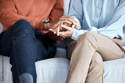 Holding hands, couple and psychology help on sofa for support, solidarity or love for growth in relationship. Black people, couch or helping hand at therapy consultation for problem, fight or anxiety