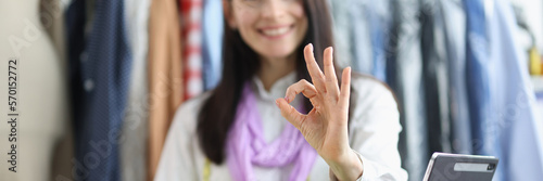 Dressmaker woman holding ok gesture while working in studio © H_Ko