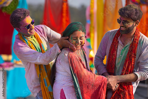 a men happily putting colour on woman during holi
