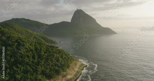 Aerial Scenic View Of Sugarloaf Mountain Under Clouds, Drone Flying Backwards Over Guanabara Bay - Rio de Janeiro, Brazil photo