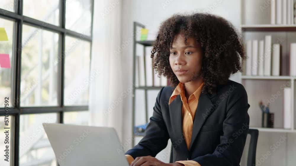 Businesswoman working on laptop and paperwork that show cost planning accounting numbers tables on office space. Businesswoman working on laptop and paperwork that show cost planning accounting numbers tables on office space.