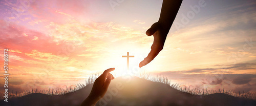 Photo God's helping hand and cross on sunset background