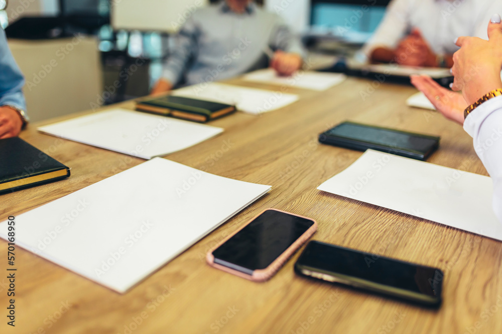 Business people sitting at desk with empty papers on desk Business people sitting at desk with empty papers on desk