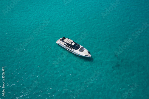 luxury white yacht anchorage on transparent water top view. © Berg