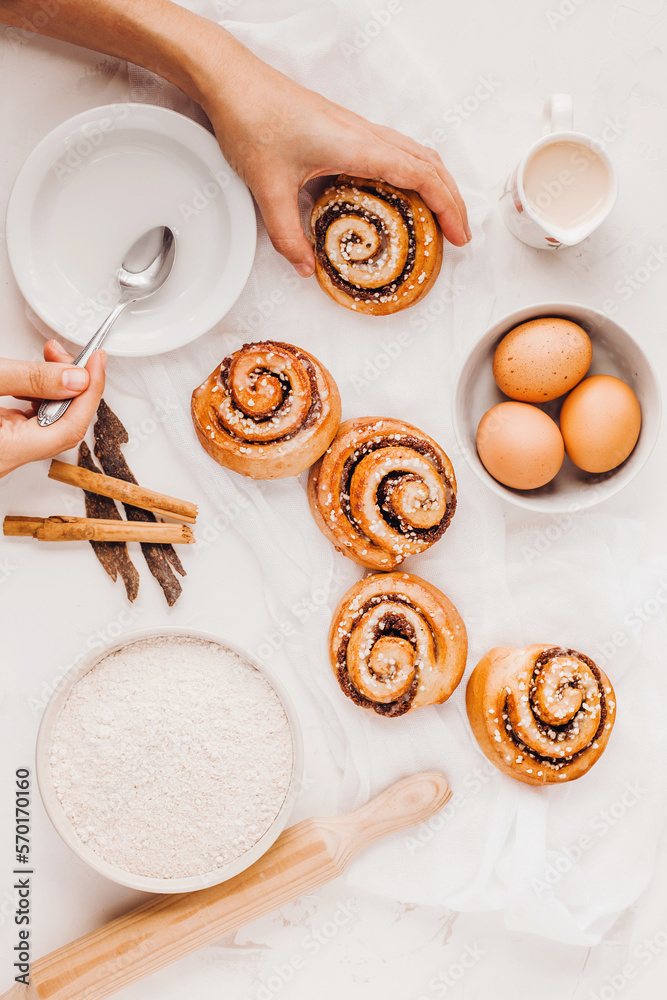hands of woman making cinnamon rolls at table, recipe ingredients hands of woman making cinnamon rolls at table, recipe ingredients