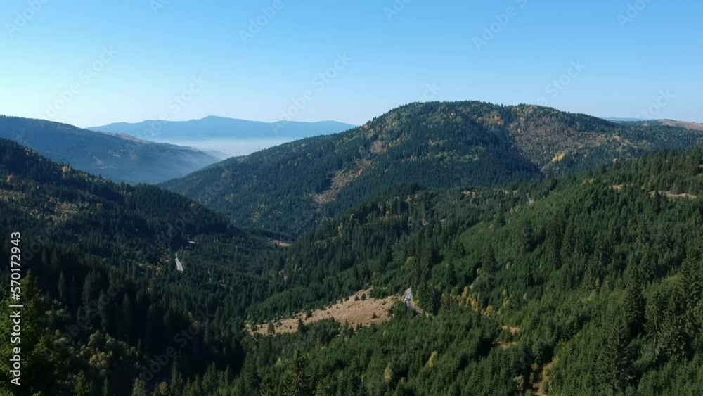 Aerial shot of a drone over mountains in Romania on a sunny day Aerial shot of a drone over mountains in Romania on a sunny day