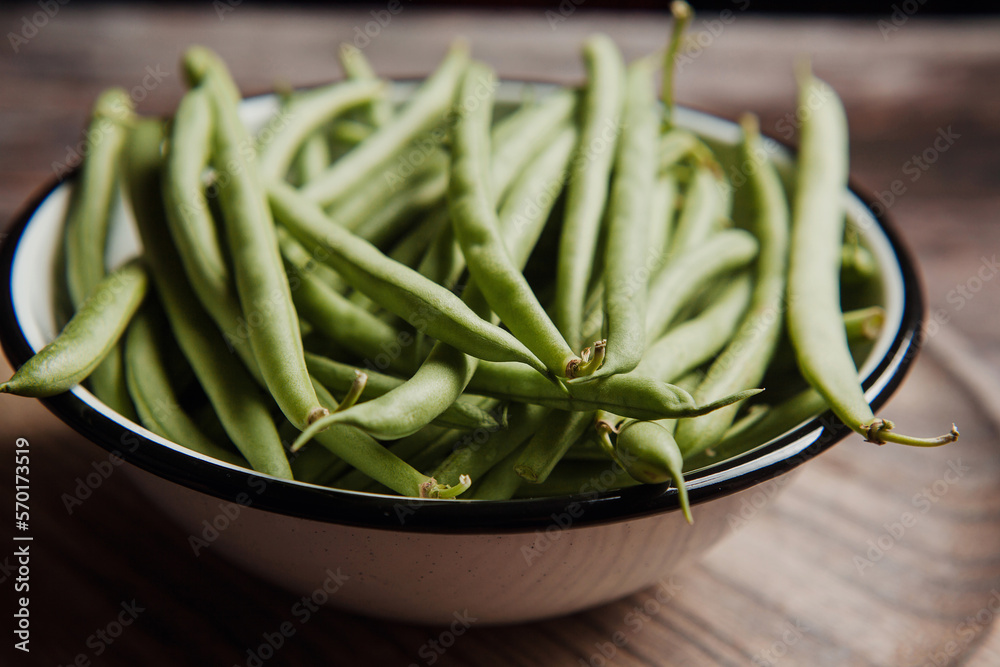Bowl of Raw Green Beans on wooden table in Mexico Latin America Bowl of Raw Green Beans on wooden table in Mexico Latin America