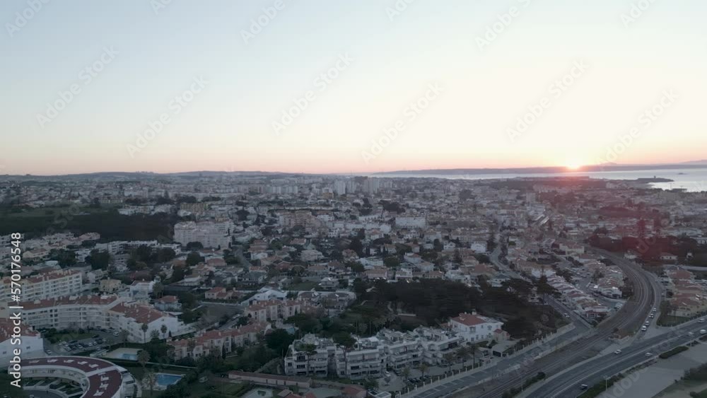 Sunrise in Cascais near of Lisbon, Portugal. Panorama and landscape of the morning city - the sea, the sky and pastel-colored houses. Sunrise in Cascais near of Lisbon, Portugal. Panorama and landscape of the morning city - the sea, the sky and pastel-colored houses.