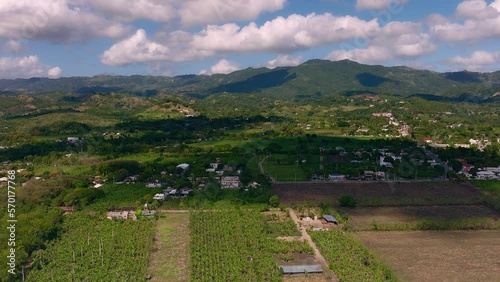 Cultivated fields in Moca countryside, Cibao region in Dominican Republic. Aerial sideways photo