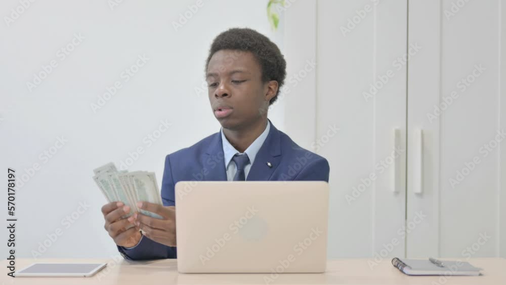 Young African Businessman Counting Dollar at Work Young African Businessman Counting Dollar at Work