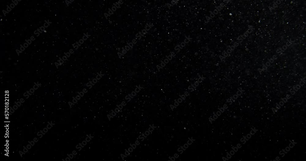 Vertical dust particles system floating on Black Screen Overlay. RED camera footage in slow motion. High quality 4k footage