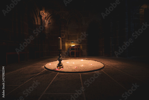 A magical mystical circle with candles in an old Gothic church © Виталий Головенько