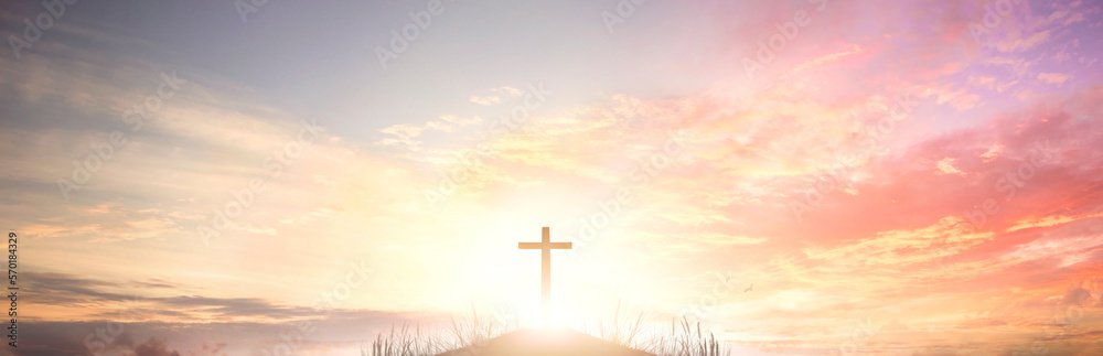 The cross of God in the rays of the sunset background
