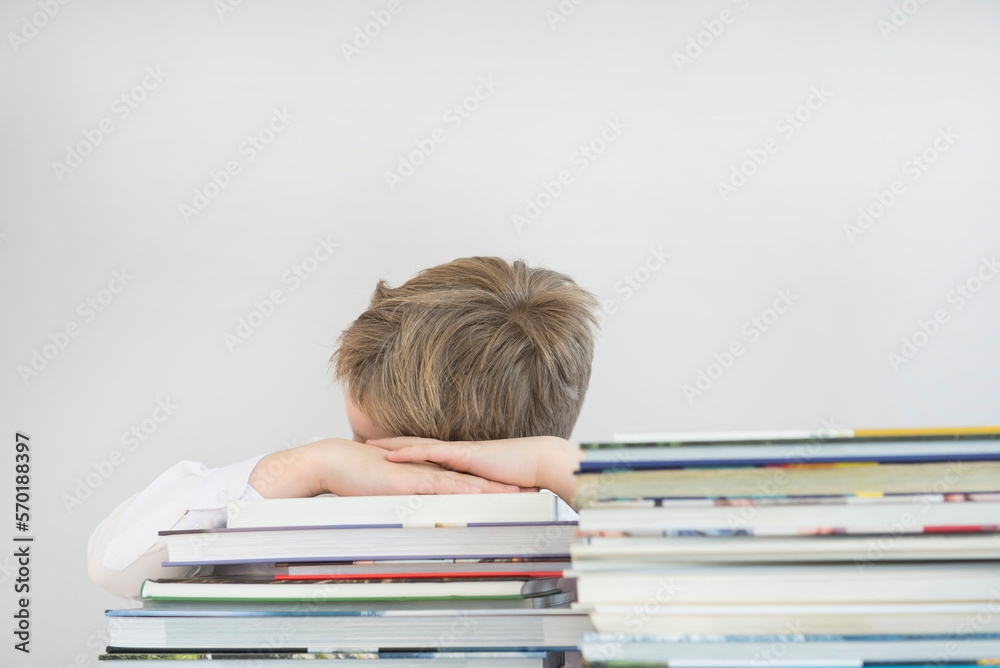 Boy sleeping on stack of books, close up Boy sleeping on stack of books, close up