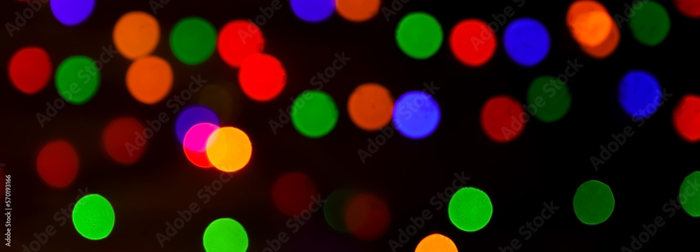 Round, bright, blurry garland lights. Abstract illustration of colorful bokeh lights on a dark background.