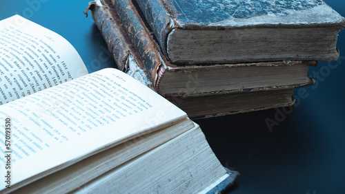 Close-up of several ancient books on a dark background. antiques. Matthew Gospel Bible 1871