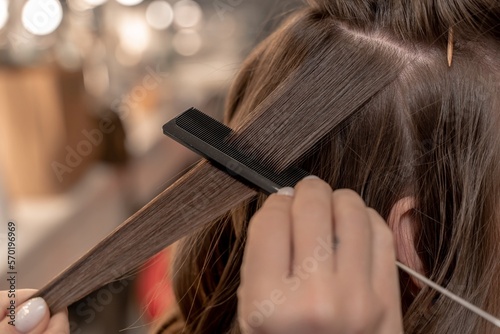 hairdresser coiffeur makes hairstyle Closeup