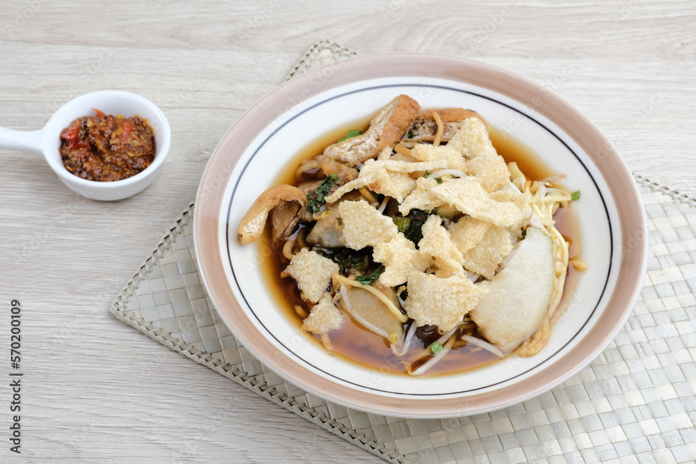 Mie Kopyok, a traditional noodle from Semarang, Central Java, Indonesia. Noodle mixed with lontong (rice cake), tofu, bean sprouts, leeks and crackers. Served with sambal (chilli sauce).
Mie Kopyok, a traditional noodle from Semarang, Central Java, Indonesia. Noodle mixed with lontong (rice cake), tofu, bean sprouts, leeks and crackers. Served with sambal (chilli sauce).