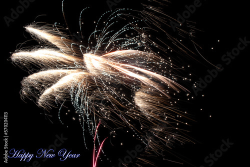 Real fireworks photography and abstract colorful fireworks background with Happy New Year lettering