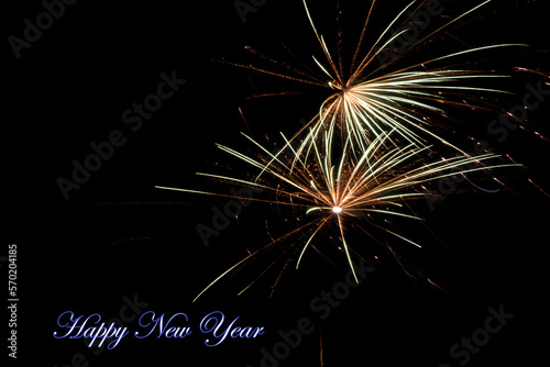 Real fireworks photography and abstract colorful fireworks background with Happy New Year lettering