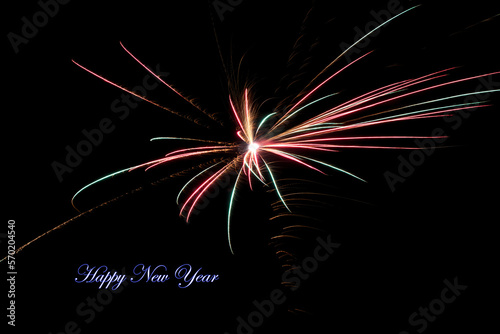Real fireworks photography and abstract colorful fireworks background with Happy New Year lettering