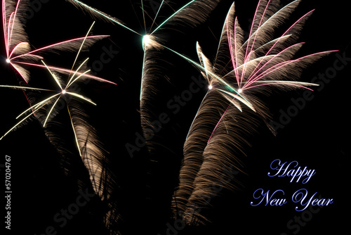 Real fireworks photography and abstract colorful fireworks background with Happy New Year lettering