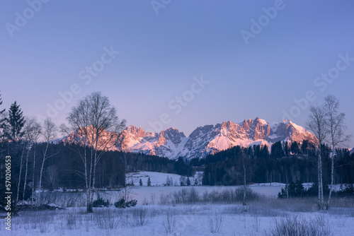 Lake „Schwarzsee“ with „Wilder Kaiser“ mountain range in winter sunrise - Kitzbühel, Tirol, Austria
