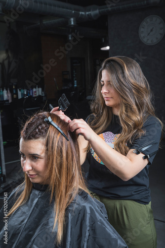 hairdresser and beautician working in her hair salon