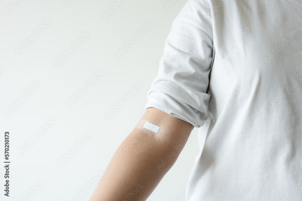 Concept of woman with plaster give blood donation to save patient life. Helping hand of blood donor. Concept of woman with plaster give blood donation to save patient life. Helping hand of blood donor.