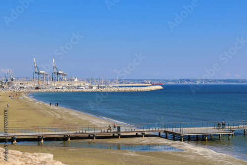 Larnaca, Cyprus March 6, 2019: View of Larnaca beach and Larnaca port on a distance photo