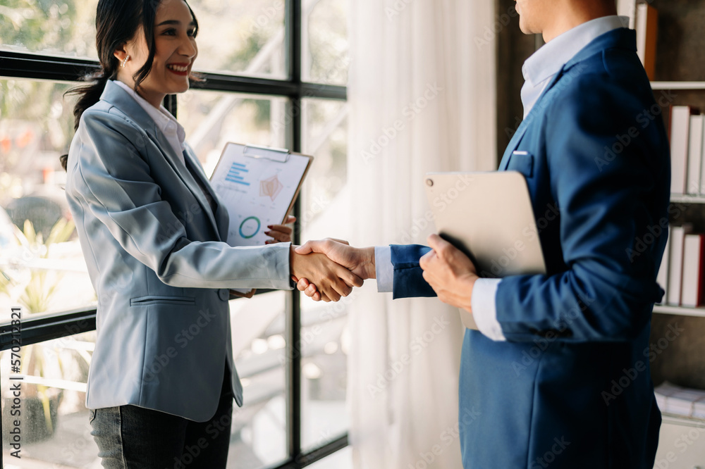 Two confident business man shaking hands during a meeting in the office, success, dealing, greeting and partner