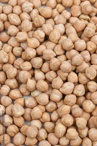 Background of dried chickpeas. Close up of chickpeas top vew. Vertical photo