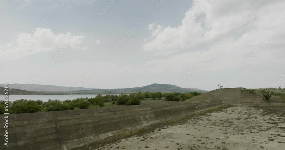 Concrete dyke and bushes above Dalis Mta reservoir dam in Georgia. Concrete dyke and bushes above Dalis Mta reservoir dam in Georgia.