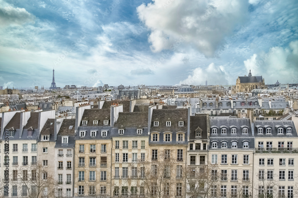 Paris, typical buildings in the Marais, aerial view with the Saint-Eustache church, the Eiffel Tower and the Defense in background 
