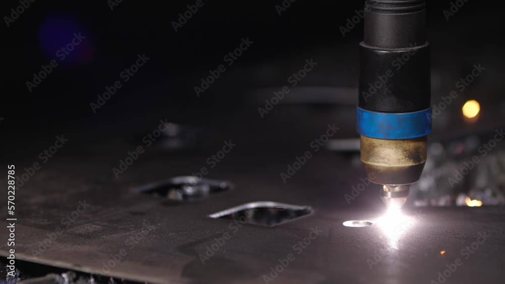 Work in the workshop for manufacture of tin products. Close up detil sho of cnc plasma machine cutting a hole in sheet metal. Sparks scatter beautifully in different directions. 200 fps slow motion Work in the workshop for manufacture of tin products. Close up detil sho of cnc plasma machine cutting a hole in sheet metal. Sparks scatter beautifully in different directions. 200 fps slow motion
