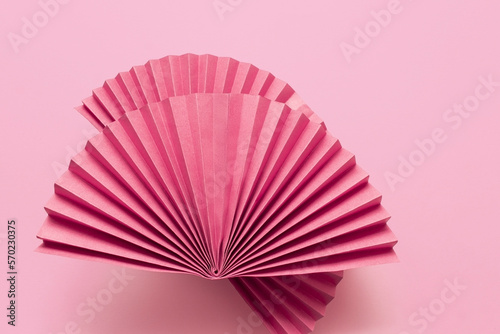 Pink circle handmade paper fans on pink background. Chinese New Year 2023 background