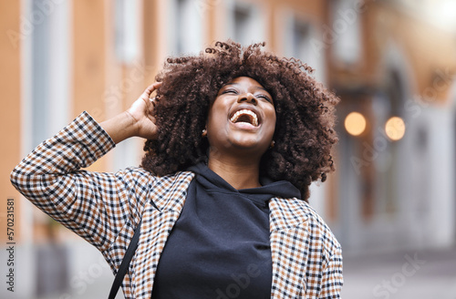 Black woman, laughing and afro hair in city fun, goofy or silly travel in urban New York or holiday location. Smile, happy or comic student in fashion, trendy or cool clothes with natural hairstyle