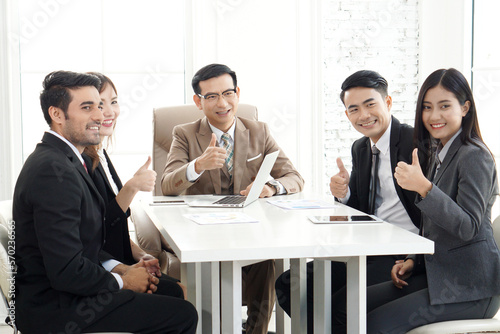 Business team show thumbs up to success business concept. Entrepreneurs are show Ok sign and smiling
