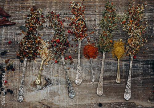 Spices in spoons. Set of indian spices in spoons on wooden board. Cooking with spices. Wood and spices