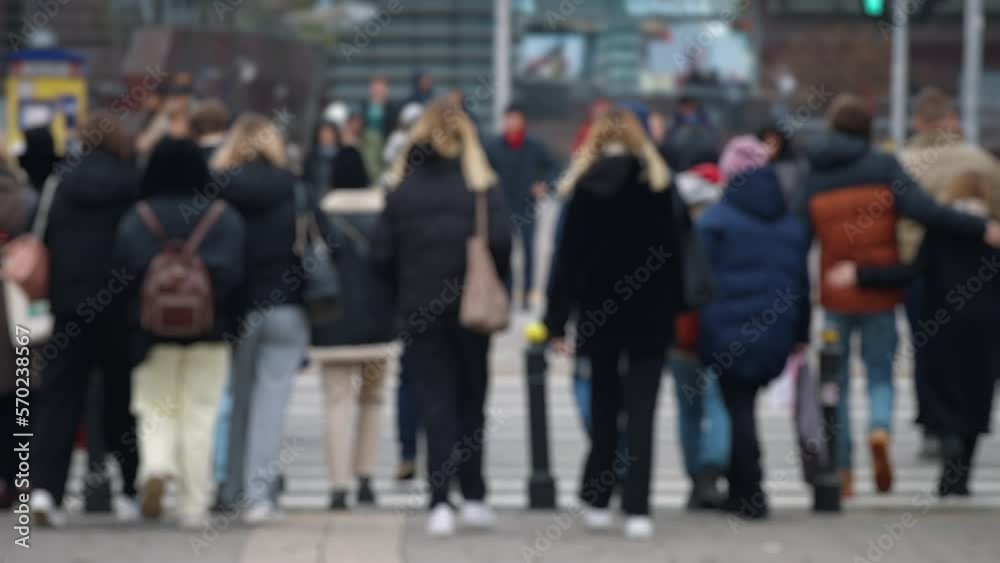 Bokeh blurred people crowd walking crossing busy urban street slow motion, city life, lot of pedestrians crowded crosswalk, rush hour intersection sidewalk autumn day. Blurry cityscape background Bokeh blurred people crowd walking crossing busy urban street slow motion, city life, lot of pedestrians crowded crosswalk, rush hour intersection sidewalk autumn day. Blurry cityscape background
