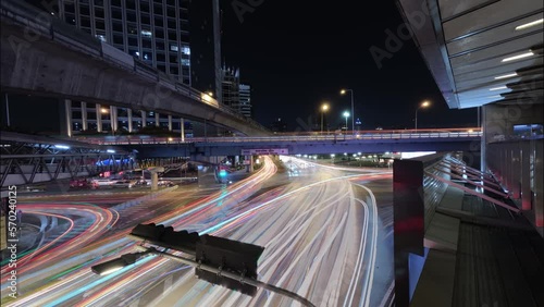 Long exposure night lapse of a busy intersection at Thai Japanese bridge in Bangkok, Thailand. photo