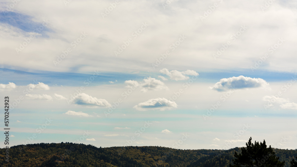 Obraz premium Landscape of clouds, blue sky and forested mountains