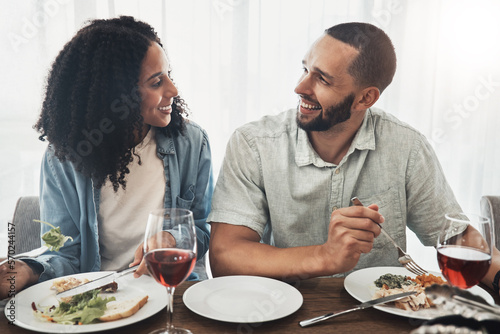 Happy young couple eating lunch with wine for celebration of love  holiday or valentines with conversation. Mexico people or woman and partner with food at home dining room table on a date together