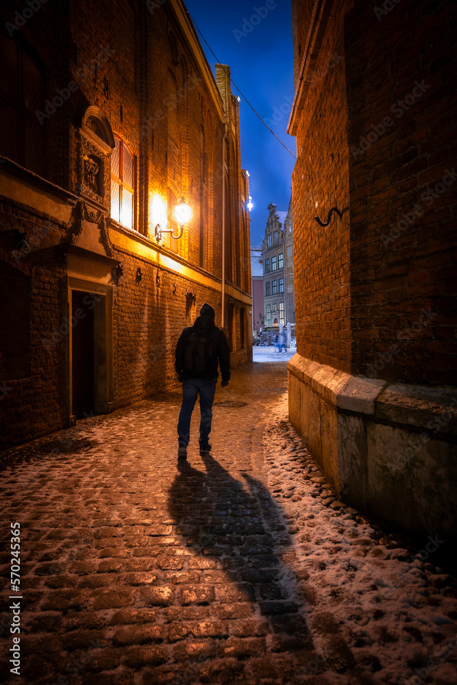 Dark street of the main city in Gdansk at snowy winter, Poland