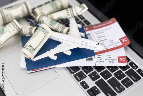 Composition with laptop, toy plane and money on color background. Travel agency