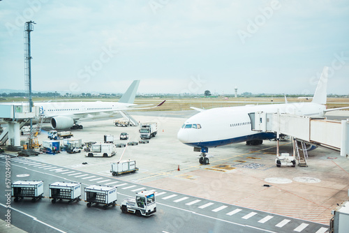 Airplane at airport, stationary transport on tarmac and runway for international passenger travel on sky horizon. Plane on ground, outdoor flight terminal and cargo carrier on aeroplane runway