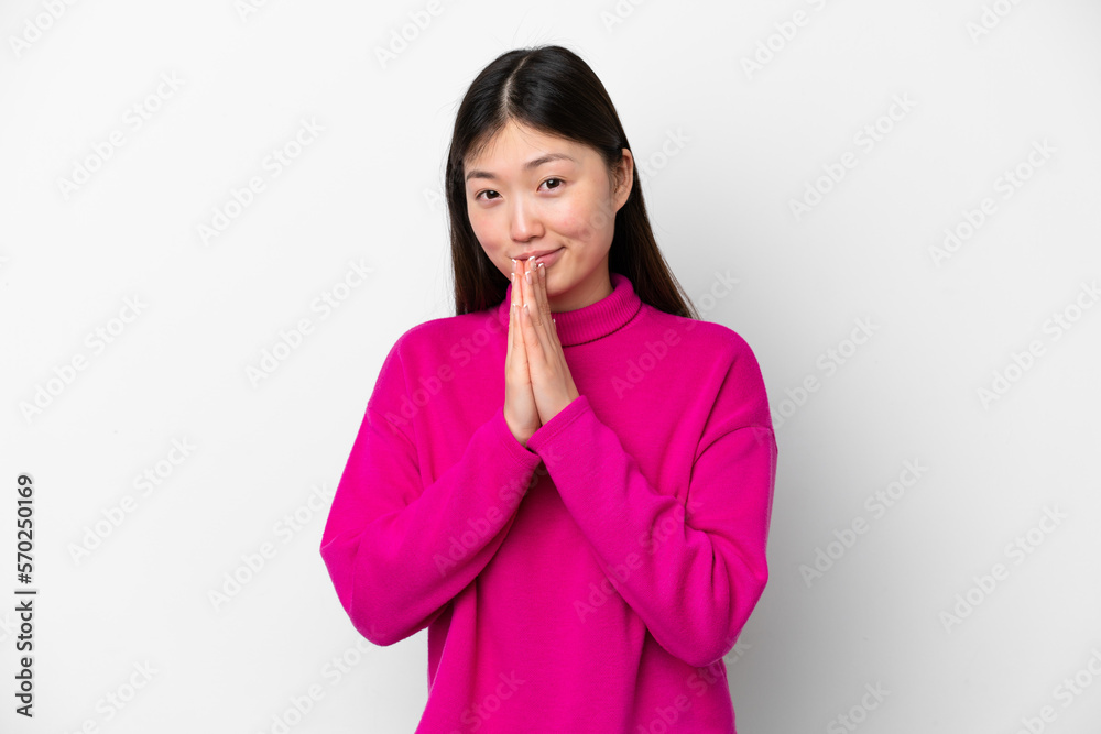 Young Chinese woman isolated on white background keeps palm together. Person asks for something Young Chinese woman isolated on white background keeps palm together. Person asks for something