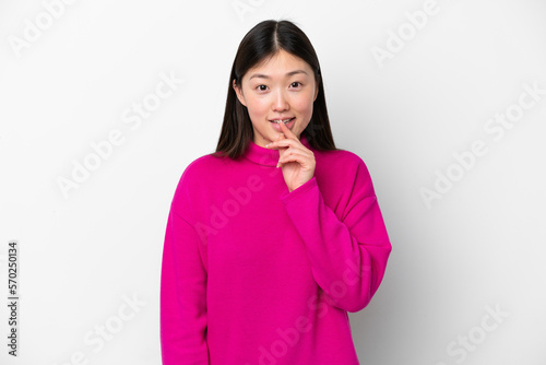 Young Chinese woman isolated on white background showing a sign of silence gesture putting finger in mouth