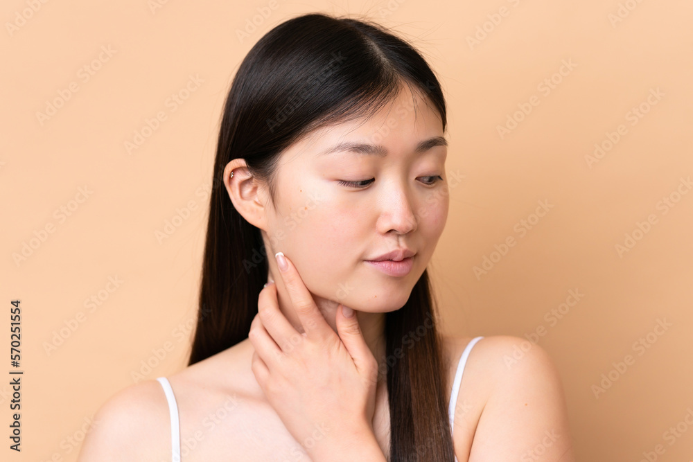 Young Chinese woman isolated on beige background . Portrait Young Chinese woman isolated on beige background . Portrait