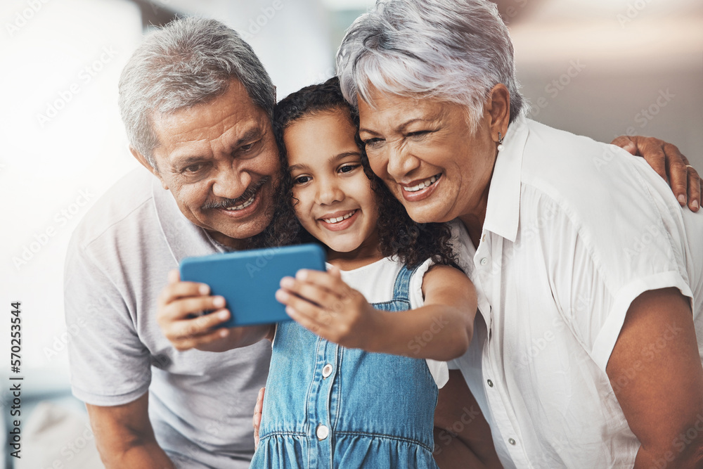 Love, happy and girl taking selfie with her grandparents for social media in modern family home. Happiness, smile and excited child taking picture with grandmother and grandfather at house in Mexico. Love, happy and girl taking selfie with her grandparents for social media in modern family home. Happiness, smile and excited child taking picture with grandmother and grandfather at house in Mexico.
